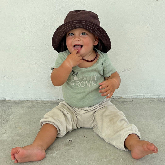 Brown corduroy bucket hat on baby.